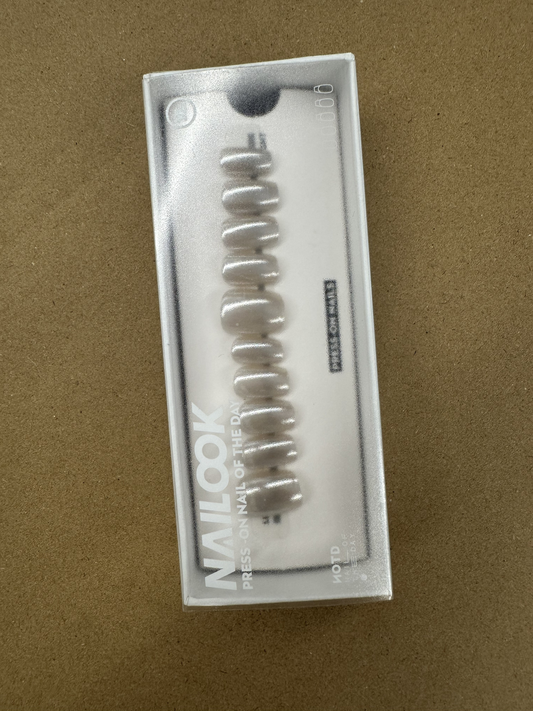 Nailook hair curler in packaging on a brown background